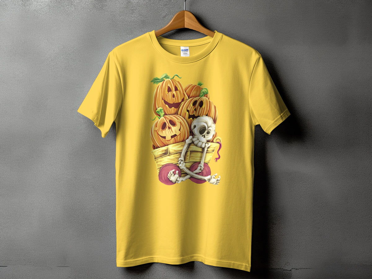 Yellow t-shirt with pumpkins and a skeleton in a wagon Halloween graphic.