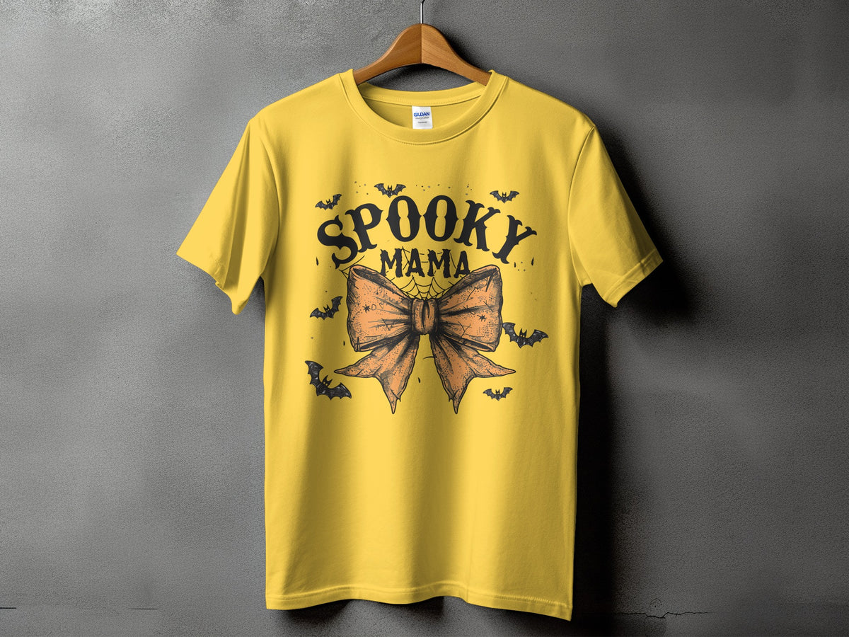 Yellow t-shirt with "Spooky Mama" text and a large orange bow.