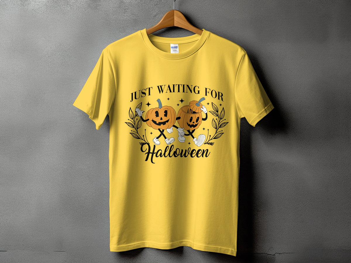 Yellow t-shirt with "Just Waiting For Halloween" text and two cartoon pumpkins.