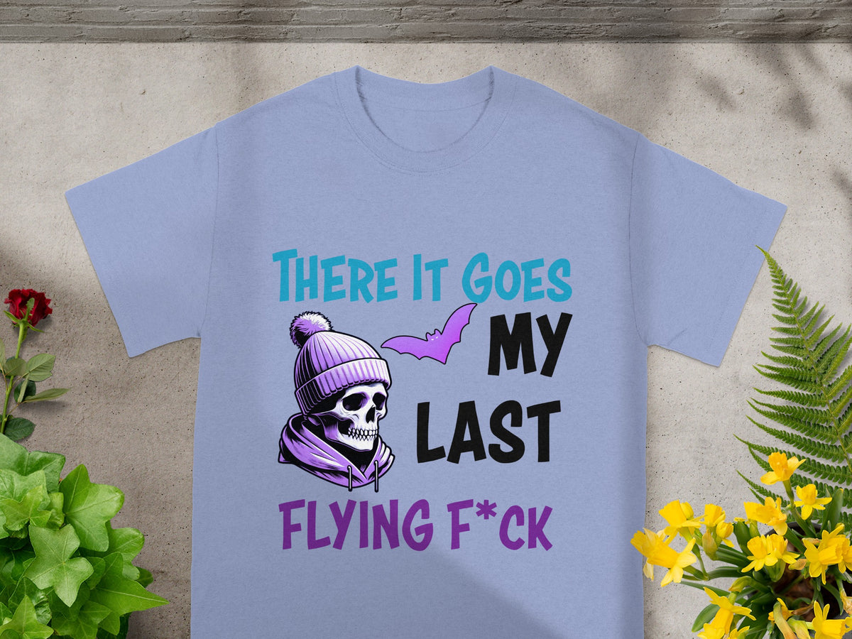 Light purple t-shirt with skull wearing a beanie and bat art, text reads "THERE IT GOES MY LAST FLYING F*CK".