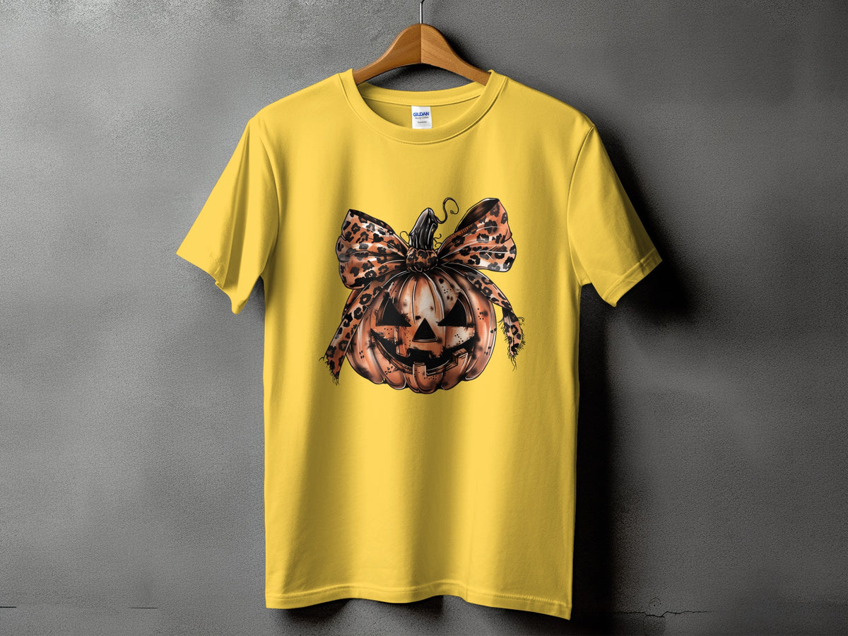 Yellow t-shirt with a distressed jack-o'-lantern and leopard print bow graphic.