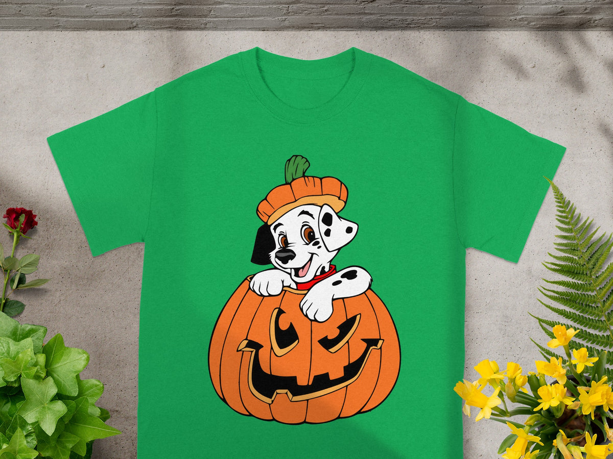 Dalmatian puppy in a pumpkin with a pumpkin hat on a green t-shirt.