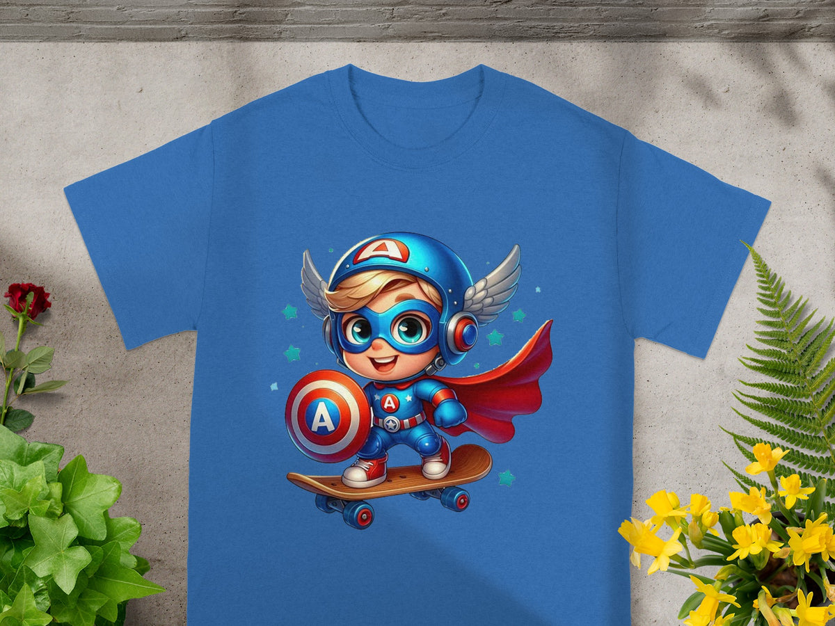 Blue t-shirt featuring a cartoon superhero boy with a shield and helmet on a skateboard.