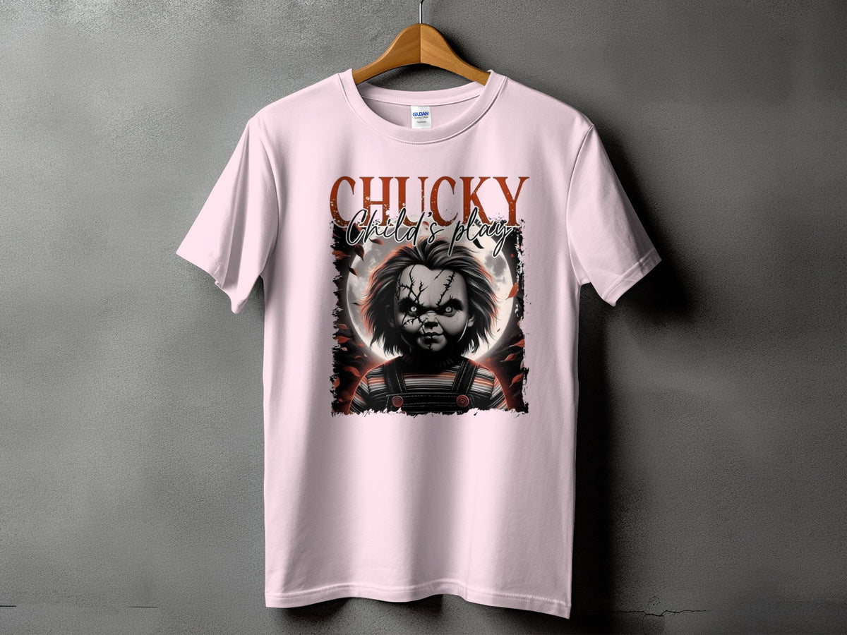 Chucky Child's Play graphic on a pink t-shirt with a full moon and bat wings.