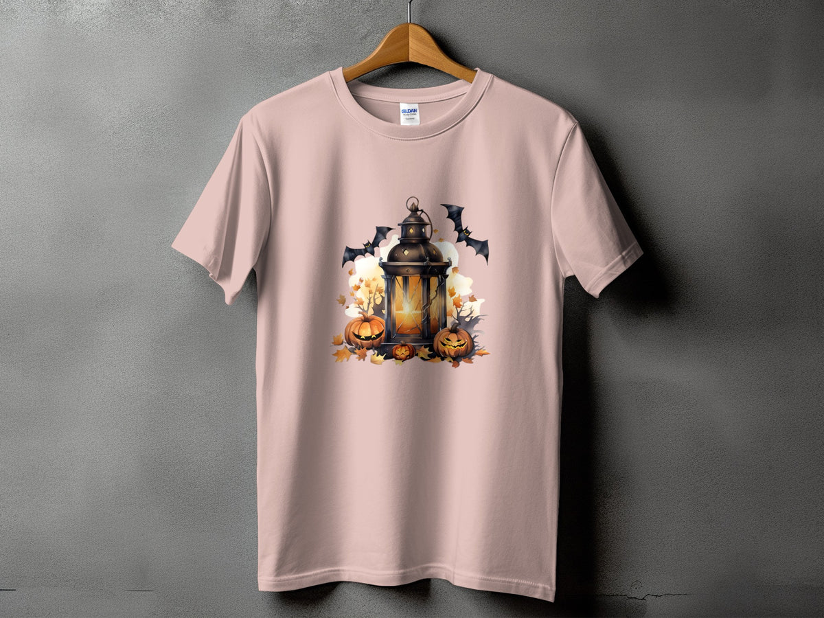 Light pink t-shirt with Halloween lantern, pumpkins, and bats graphic design.