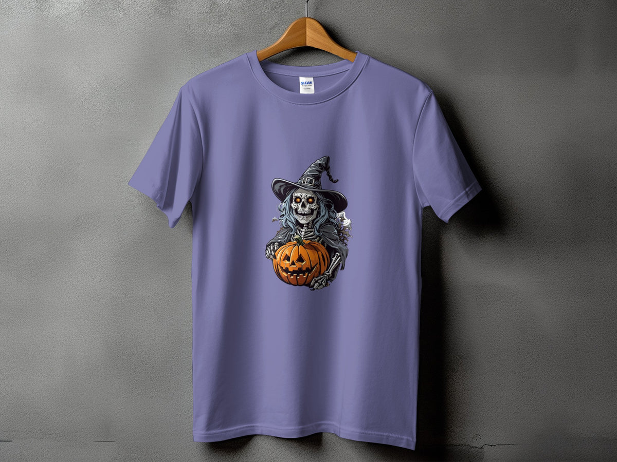 Skeleton wearing a witch hat holding a jack-o'-lantern on a lavender t-shirt.