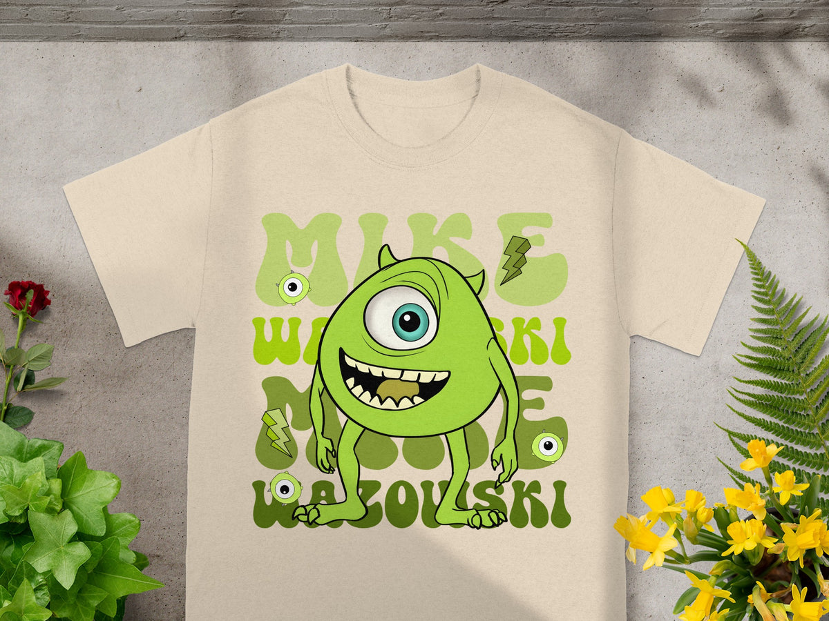 Mike Wazowski character on a beige t-shirt with green text.