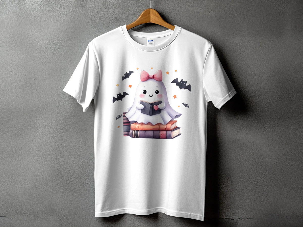 White t-shirt with a cute ghost reading a book surrounded by bats and stars.
