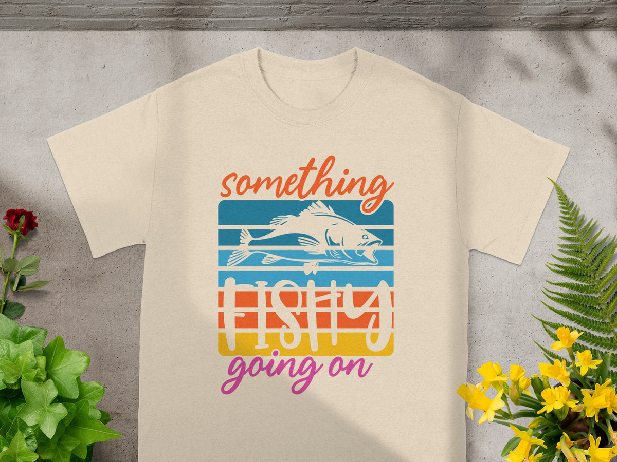 Cream t-shirt with "something fishy going on" text and a stylized fish design.