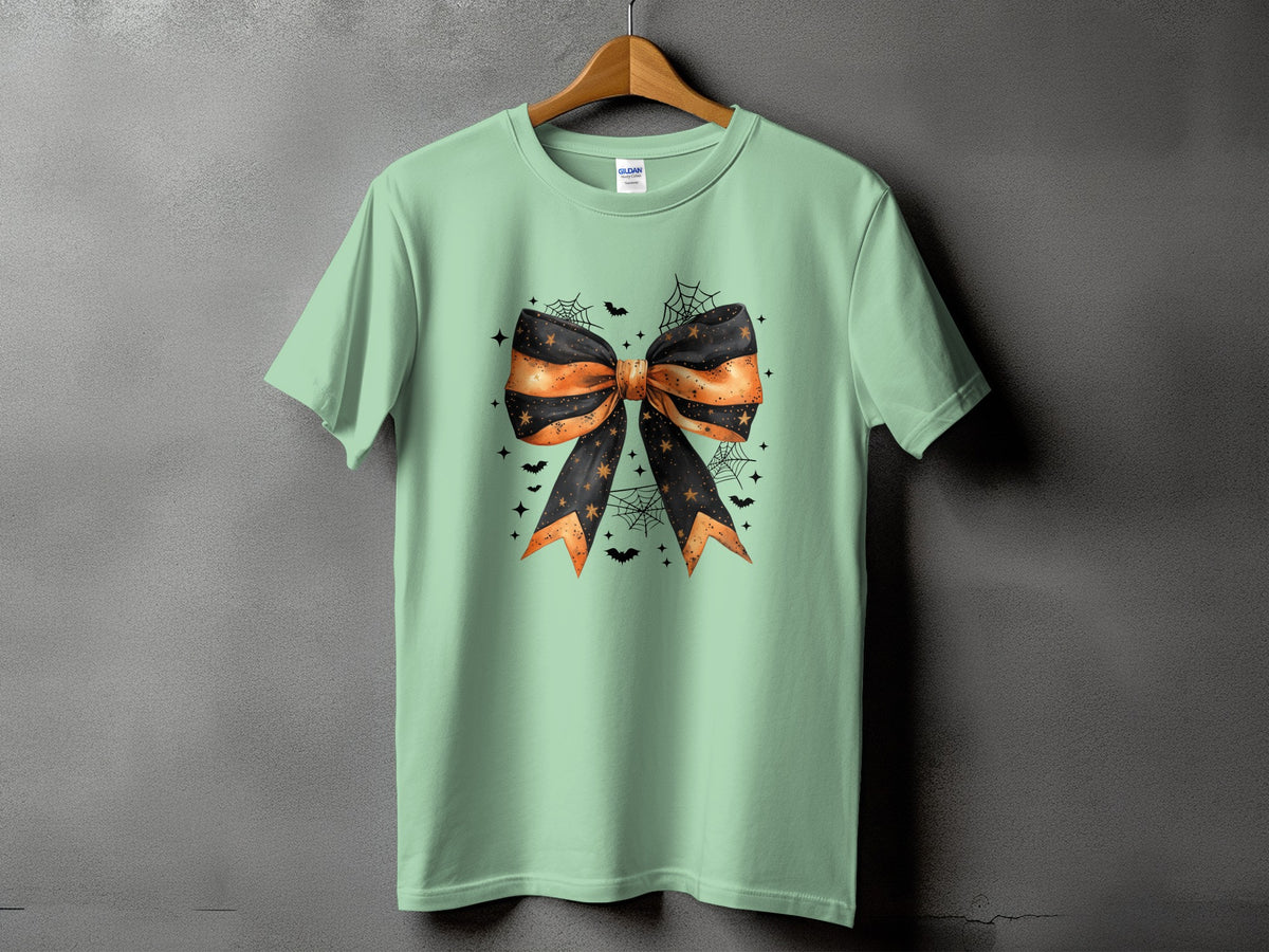 Mint green t-shirt with a Halloween bow graphic, spiders, bats, and stars.