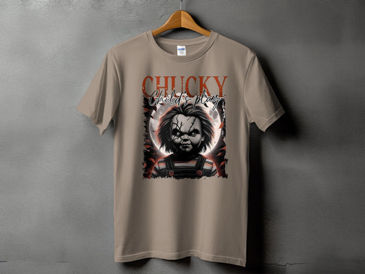 Chucky Child's Play graphic on a tan t-shirt with a wooden hanger.