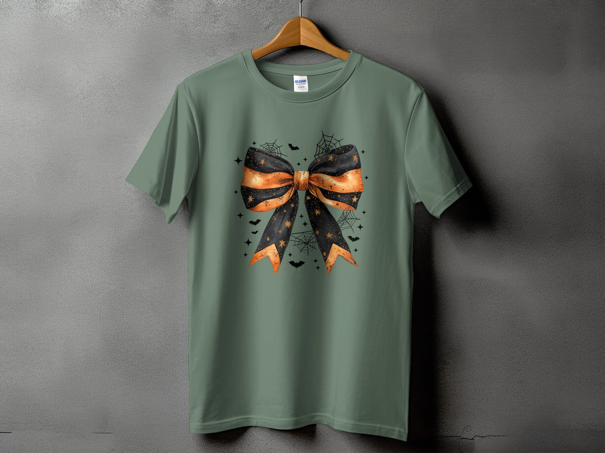 Green t-shirt with a Halloween-themed bow, bats, stars, and spiderwebs graphic.