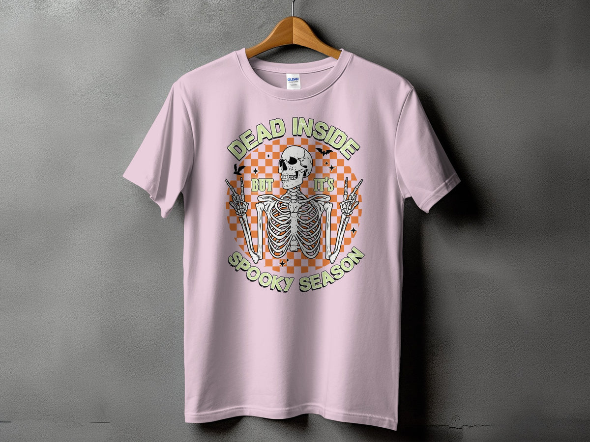 Pink t-shirt with a skeleton graphic and text "DEAD INSIDE BUT IT'S SPOOKY SEASON."