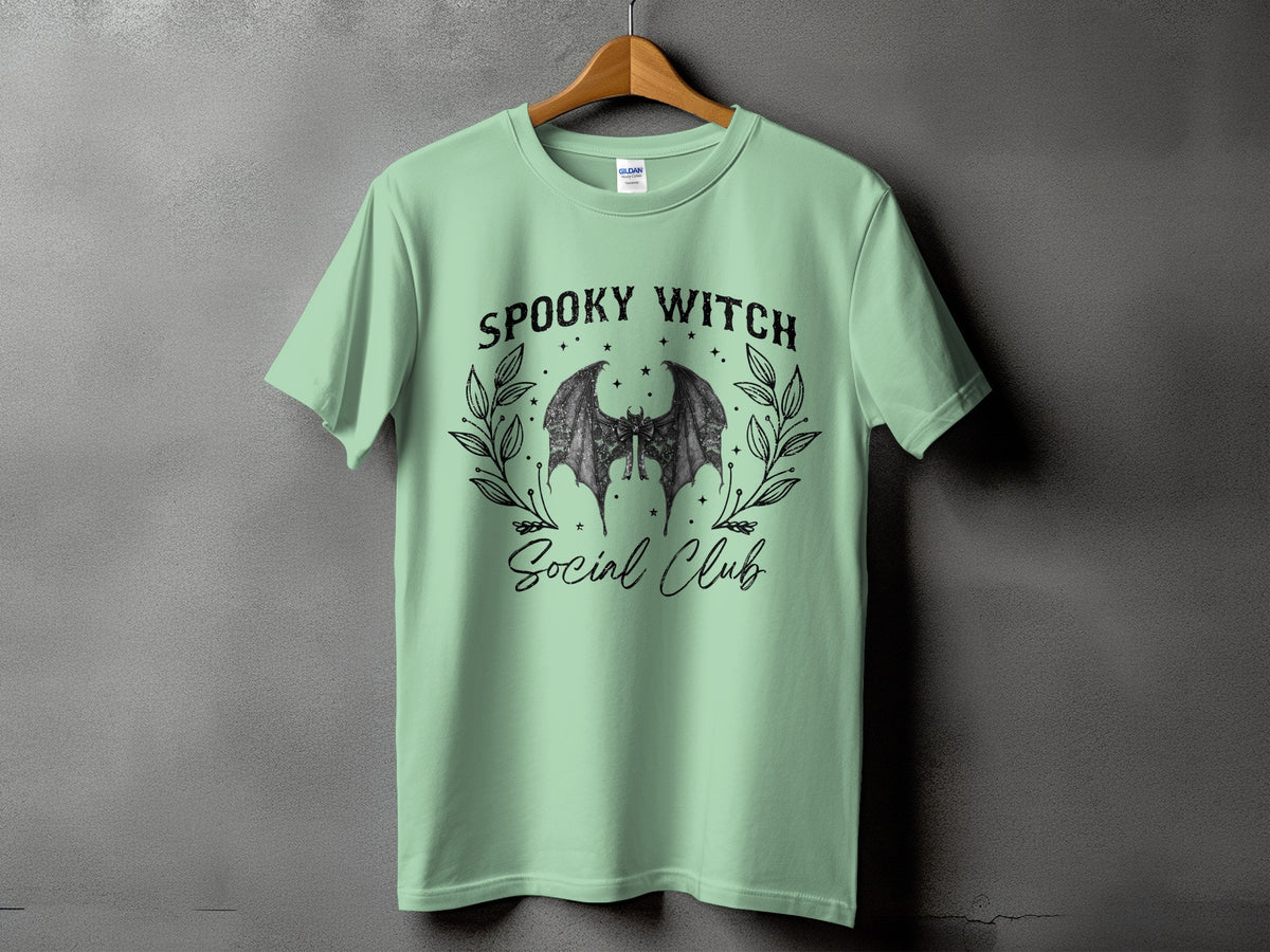 Green t-shirt with "Spooky Witch Social Club" text and bat wings graphic.