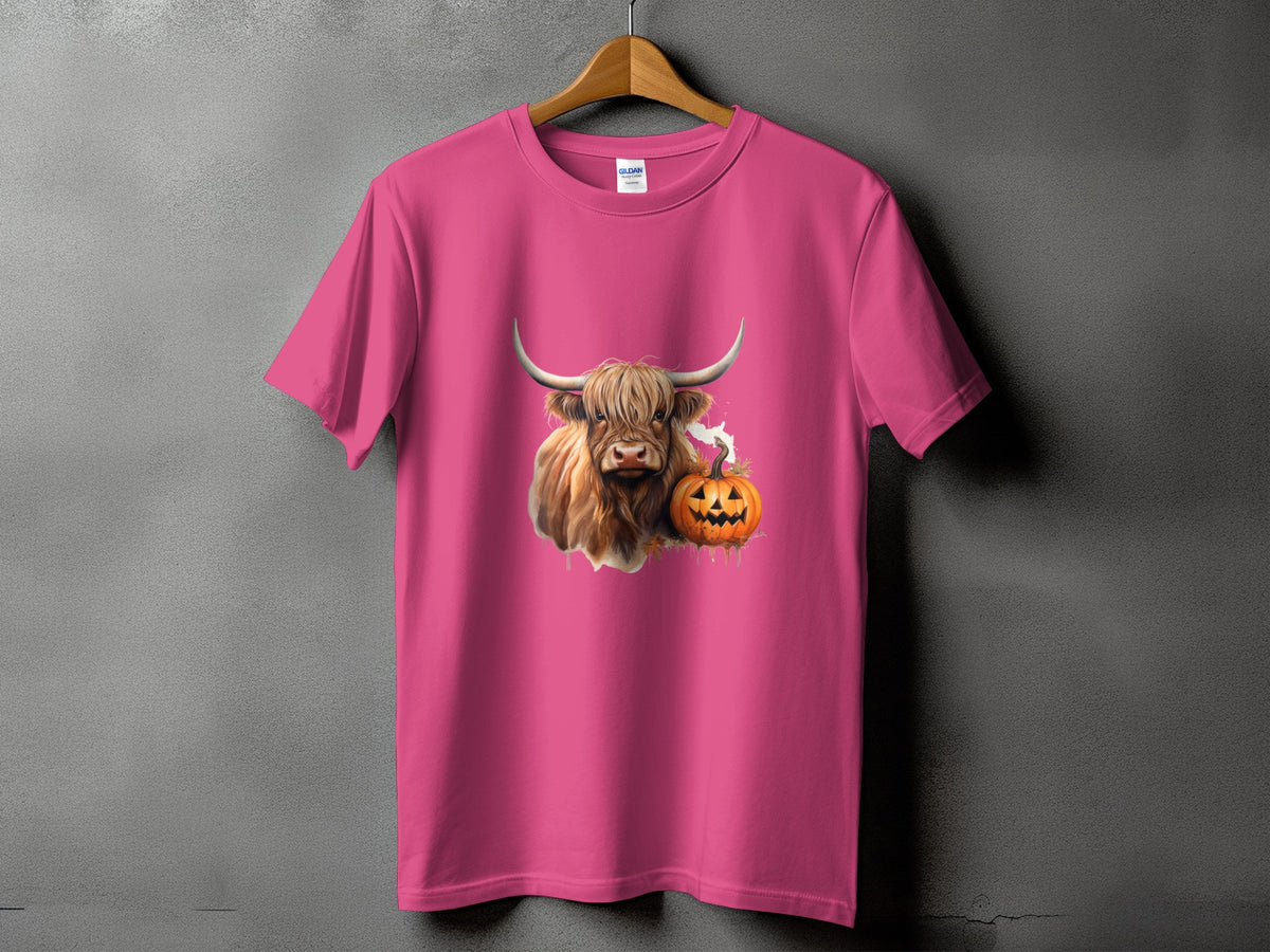 Pink t-shirt with a Highland cow and jack-o'-lantern graphic.