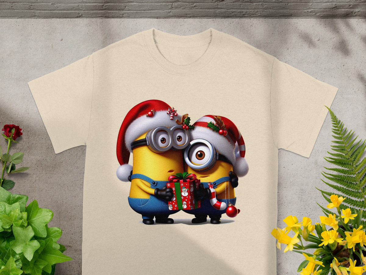 Two Minion characters in Santa hats hug, holding a Christmas gift and candy cane.