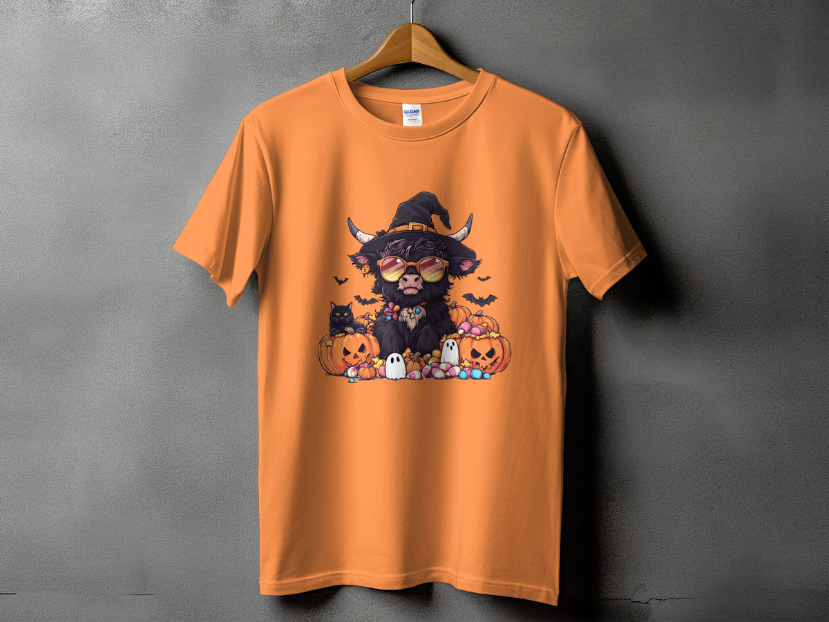 Orange t-shirt with Halloween graphic of a cow wearing a witch hat and sunglasses.