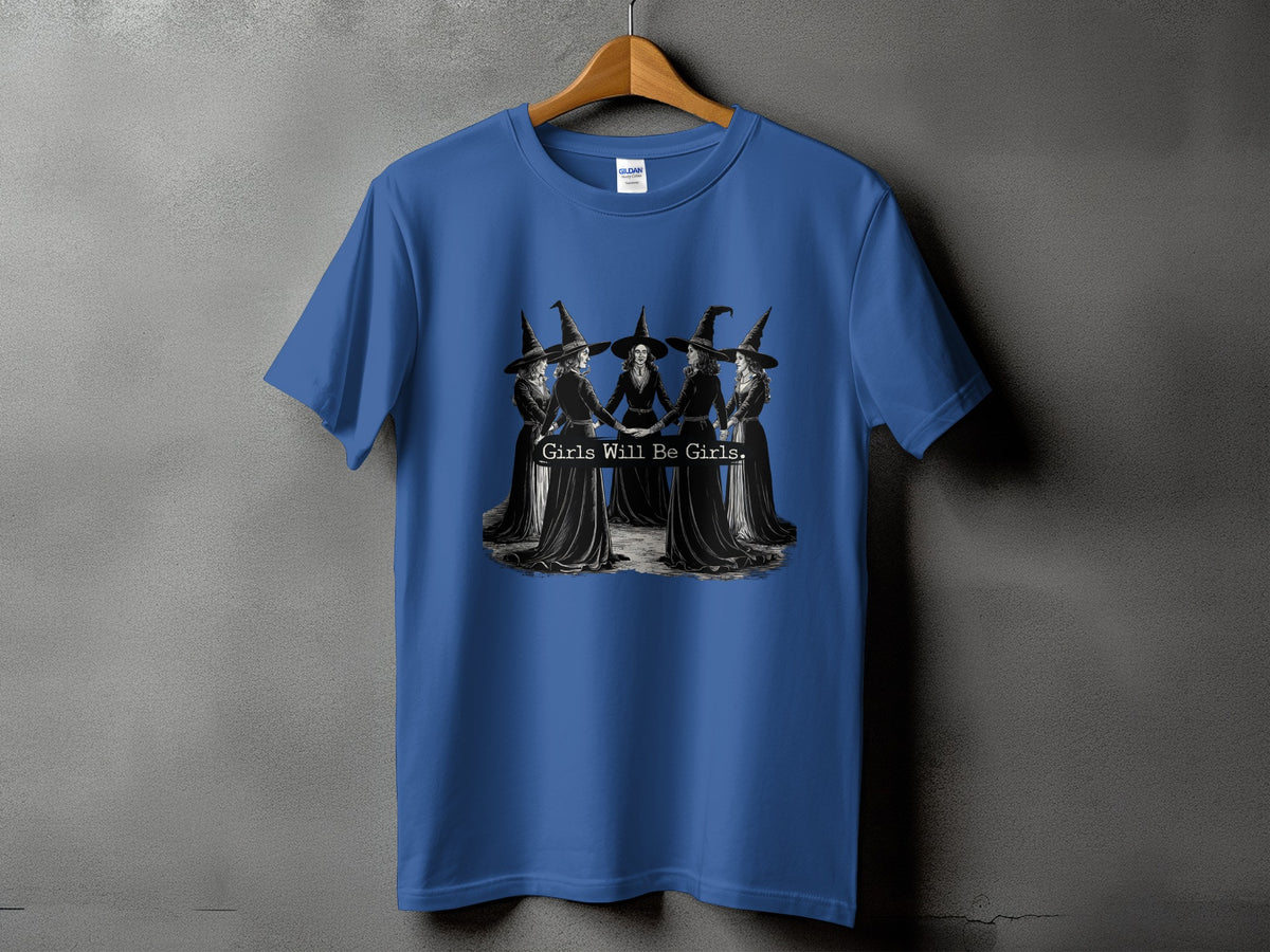 Blue t-shirt with a graphic of witches holding hands and the text "Girls Will Be Girls."