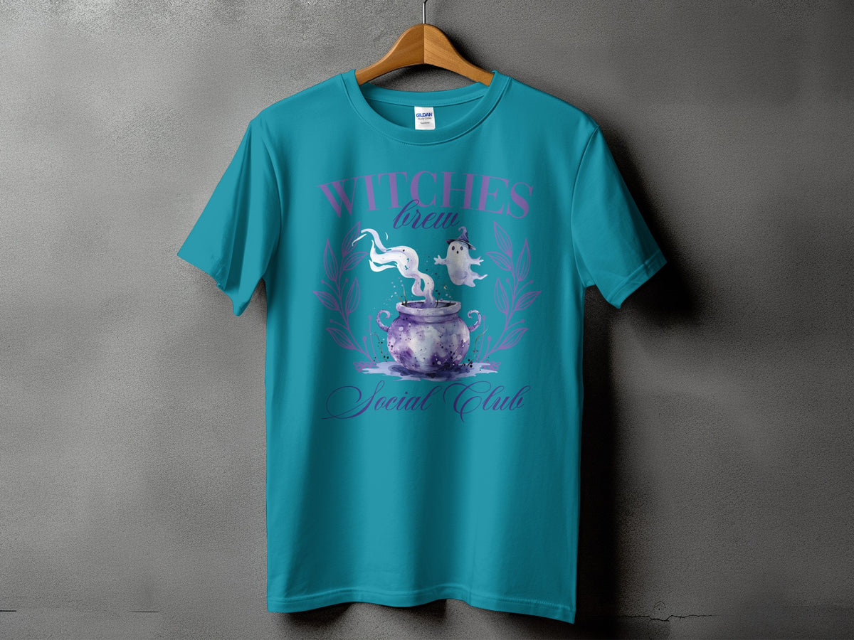 Teal t-shirt with "Witches Brew Social Club" text and spooky cauldron graphic.