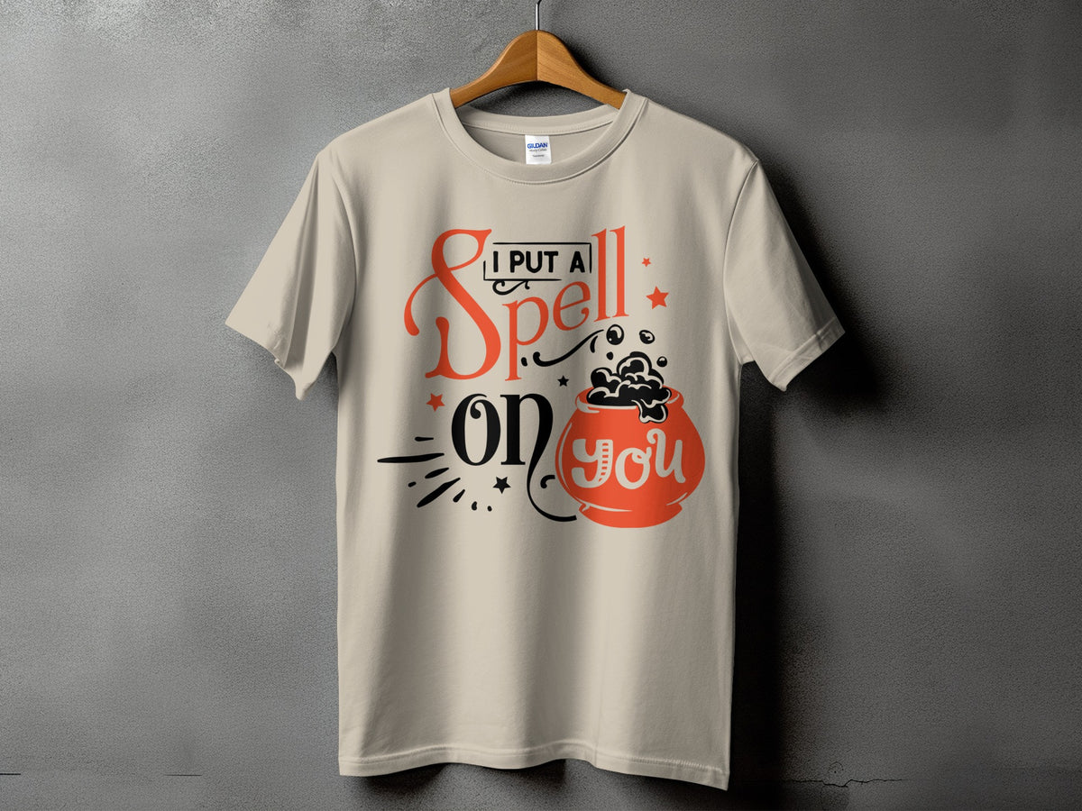 Light tan t-shirt with "I put a spell on you" text and cauldron graphic.