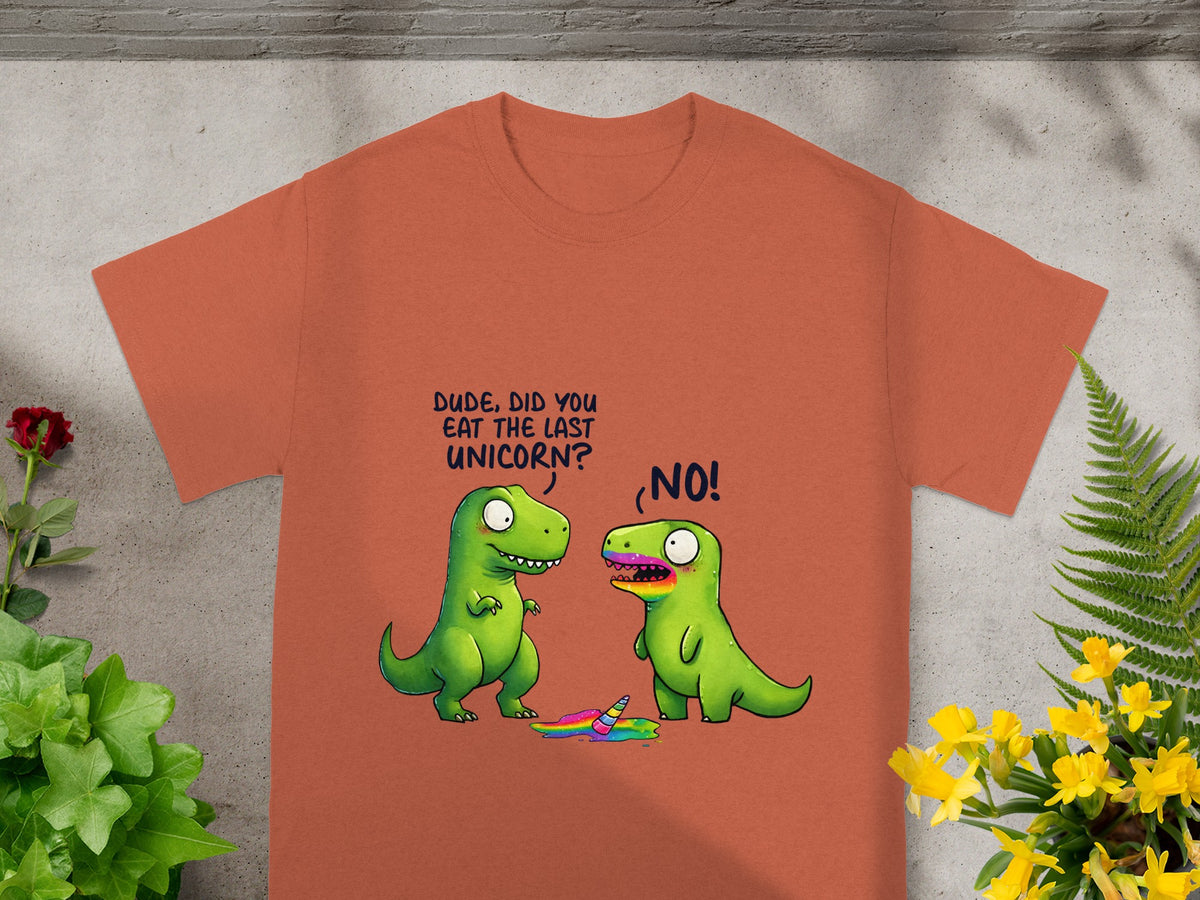 Orange t-shirt with cartoon dinosaurs and a melted unicorn. Text reads: "DUDE, DID YOU EAT THE LAST UNICORN?" "NO!"