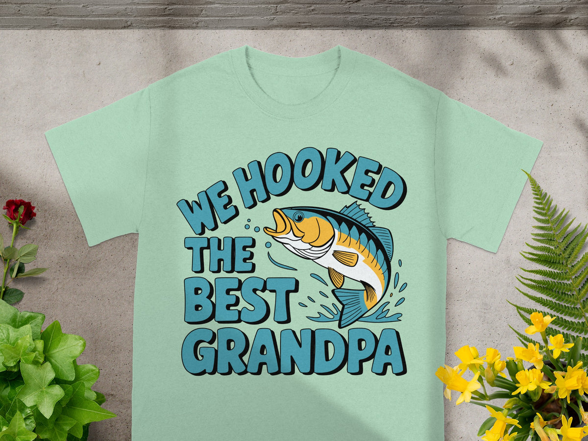 T-shirt with graphic of a leaping fish and text "WE HOOKED THE BEST GRANDPA".