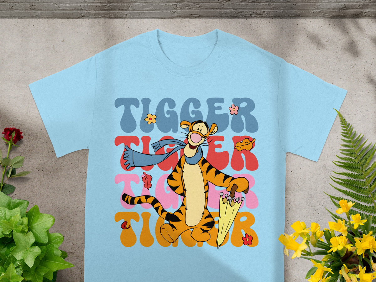 Tigger with umbrella and scarf, "Tigger" text in colorful wavy font.