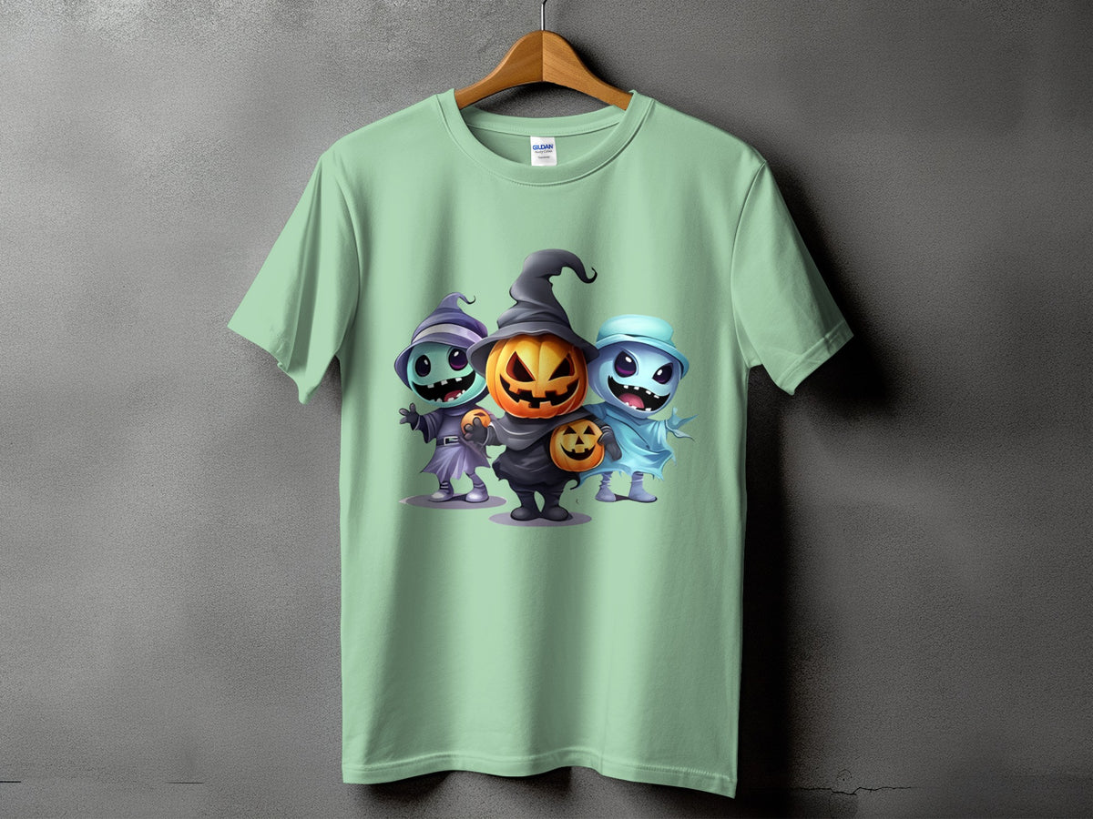 Light green t-shirt with three cartoon Halloween characters: witch, jack-o'-lantern, and ghost.