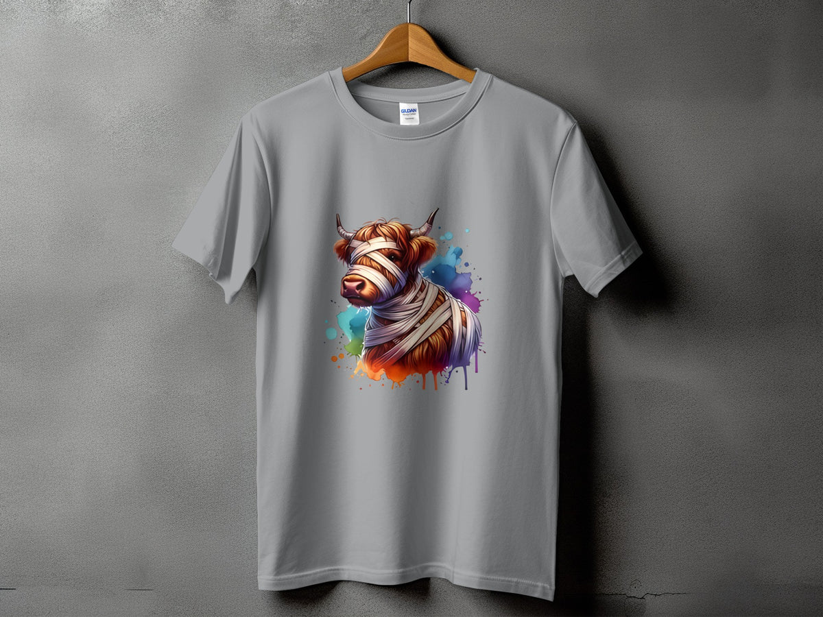 Grey t-shirt with a watercolor-style graphic of a cow wrapped in bandages.