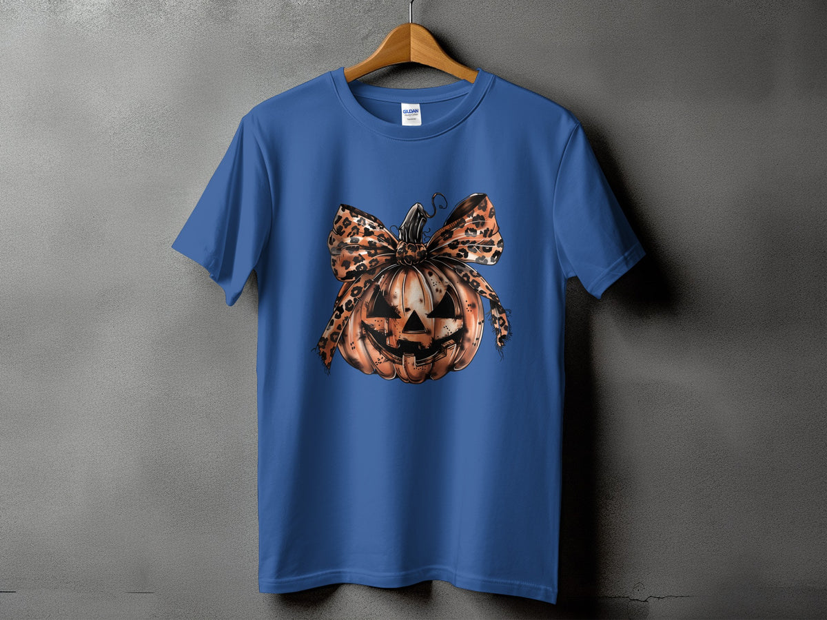 Blue t-shirt with a jack-o'-lantern graphic featuring a leopard print bow.