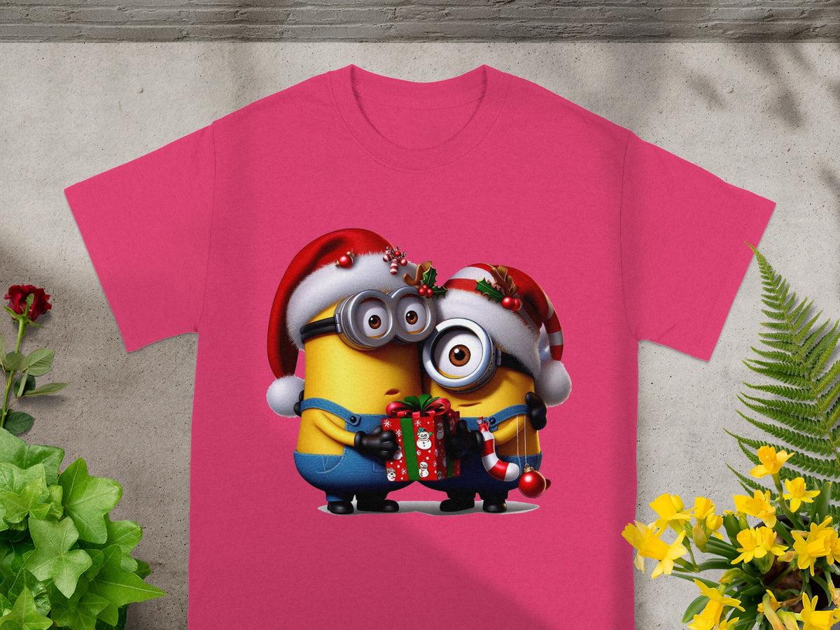 Two Minions in Santa hats hold a gift and candy cane on a pink t-shirt.