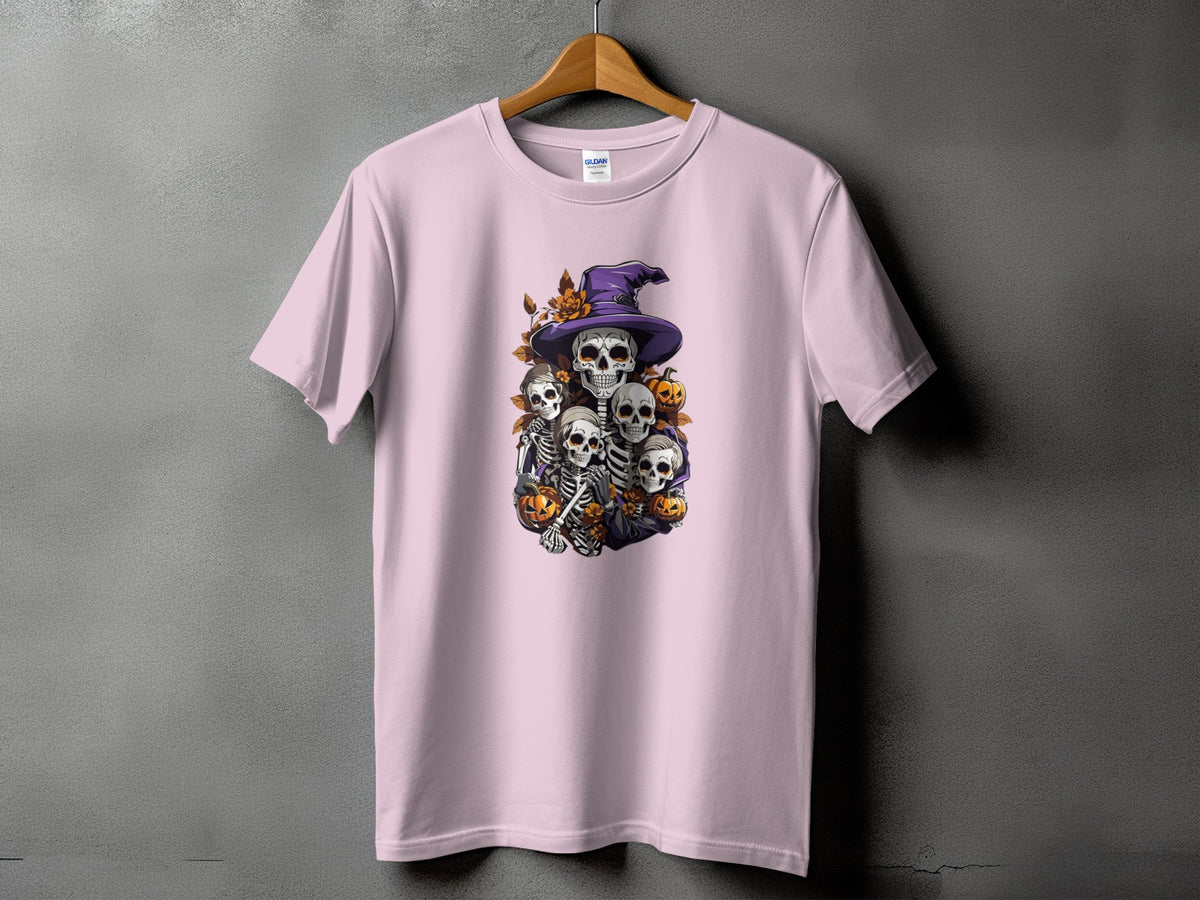 Skeleton Halloween design with witch hat, pumpkins and autumn leaves on a pink t-shirt.