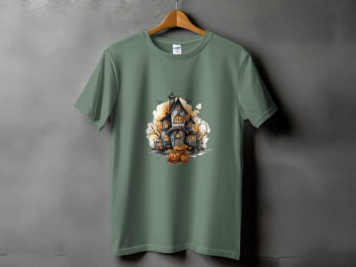 Green t-shirt with a watercolor illustration of a haunted house and pumpkins.