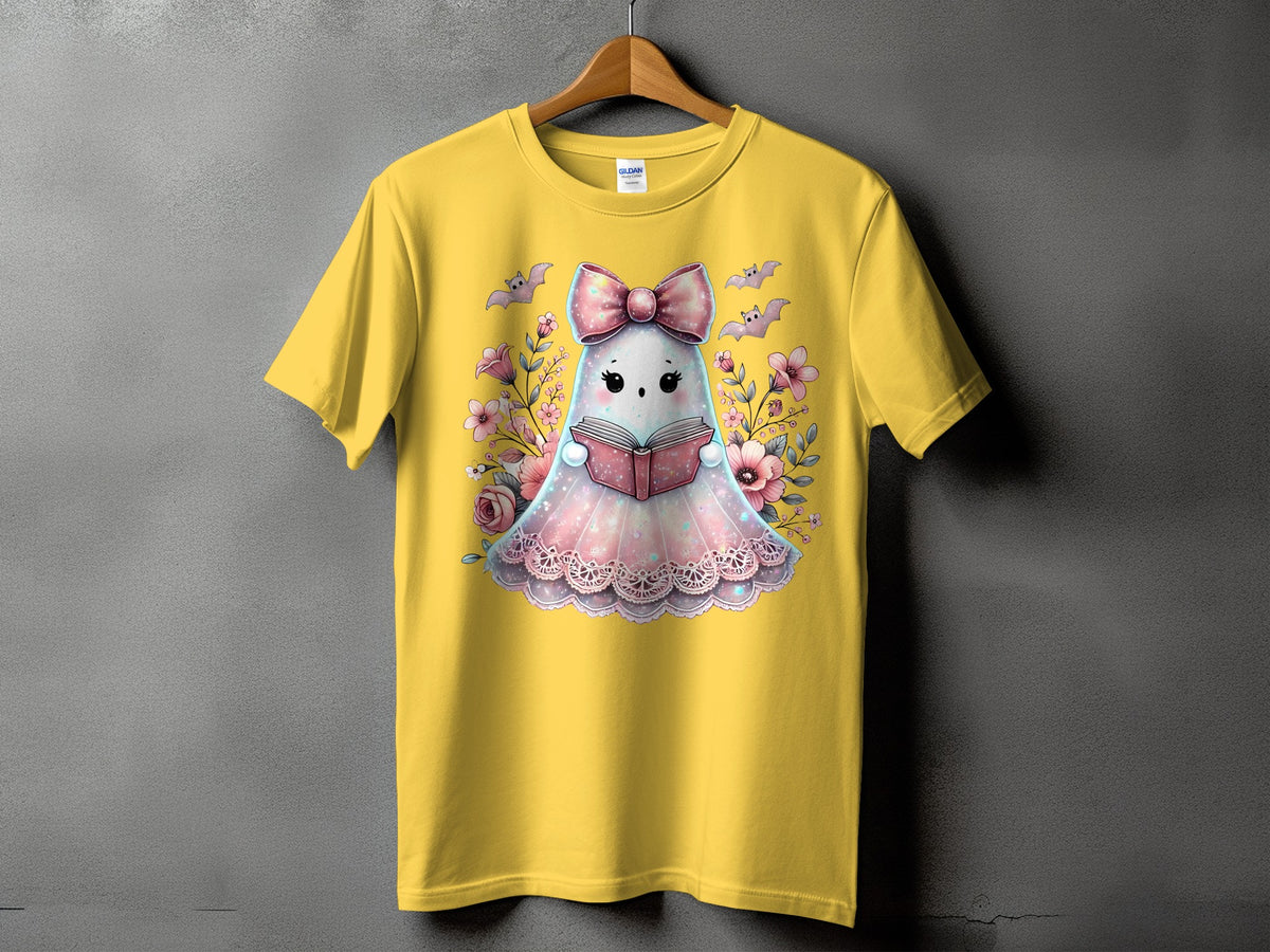 Yellow t-shirt with cute ghost reading a book surrounded by flowers and bats.