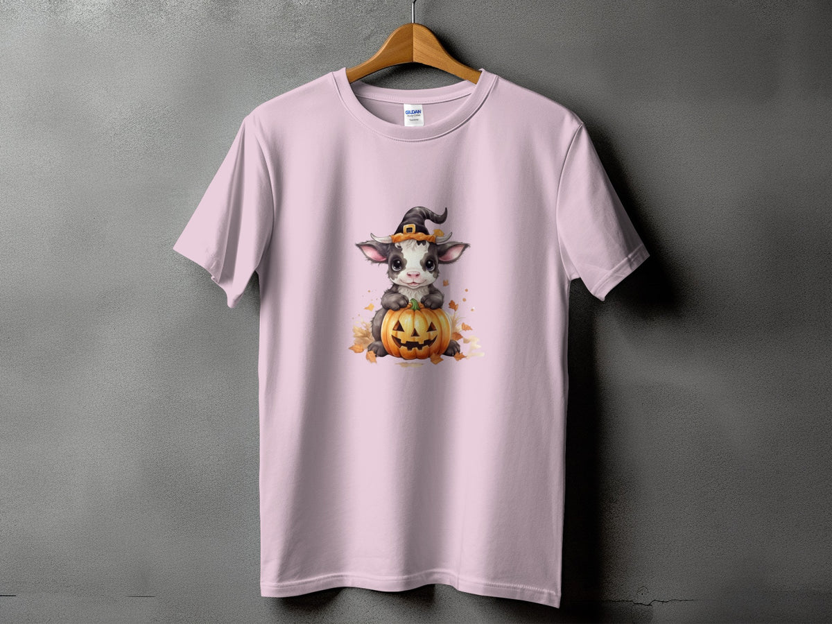 Pink t-shirt with a cow wearing a witch hat on a pumpkin graphic.