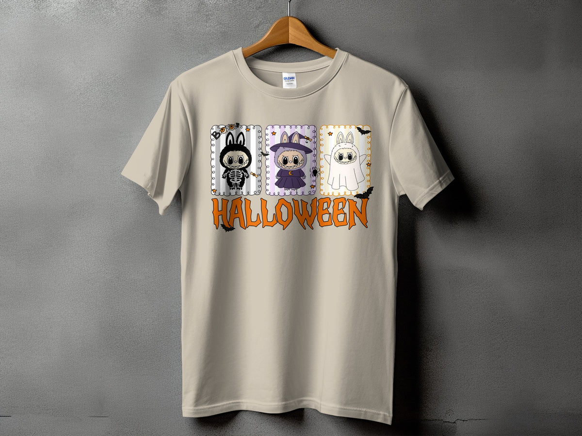 Light tan t-shirt with Halloween graphic featuring three costumed bunnies and the word Halloween.