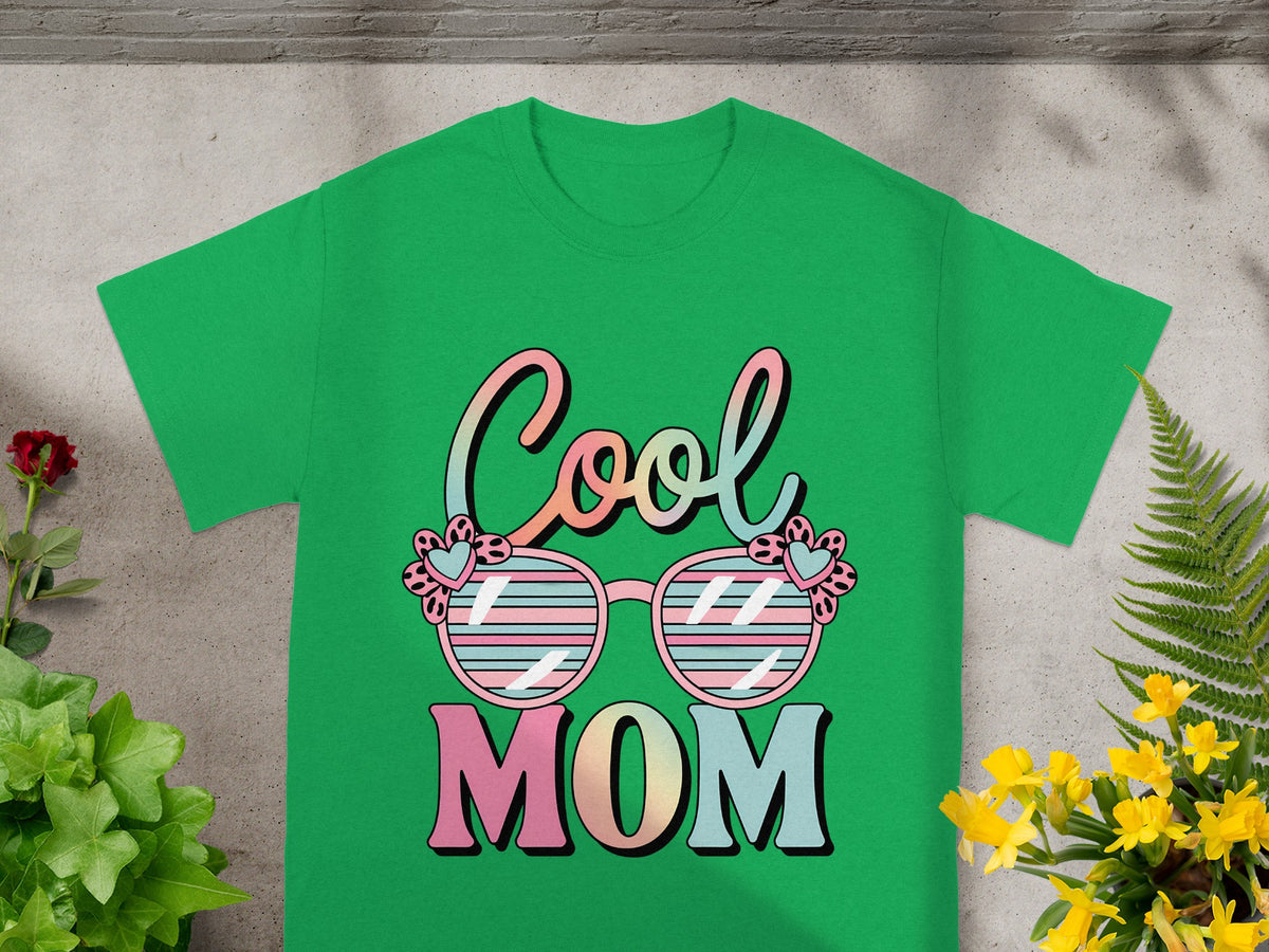 Green t-shirt with "Cool Mom" text and striped sunglasses design.