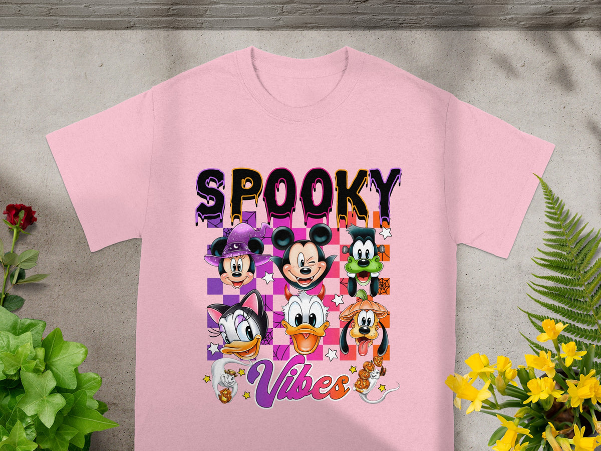 Disney characters with "Spooky Vibes" text and Halloween costumes on a pink t-shirt.