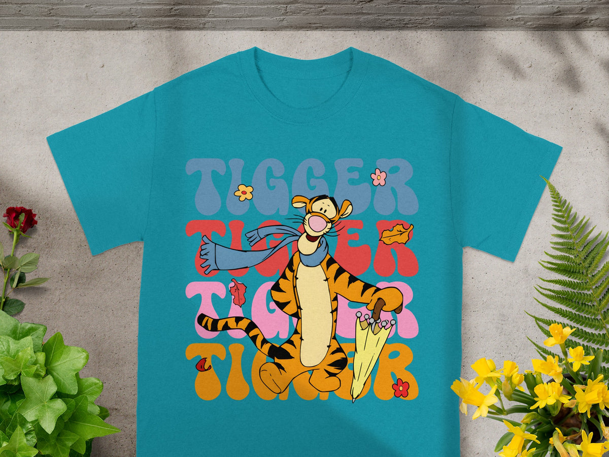 Tigger character with umbrella and leaves on teal t-shirt.