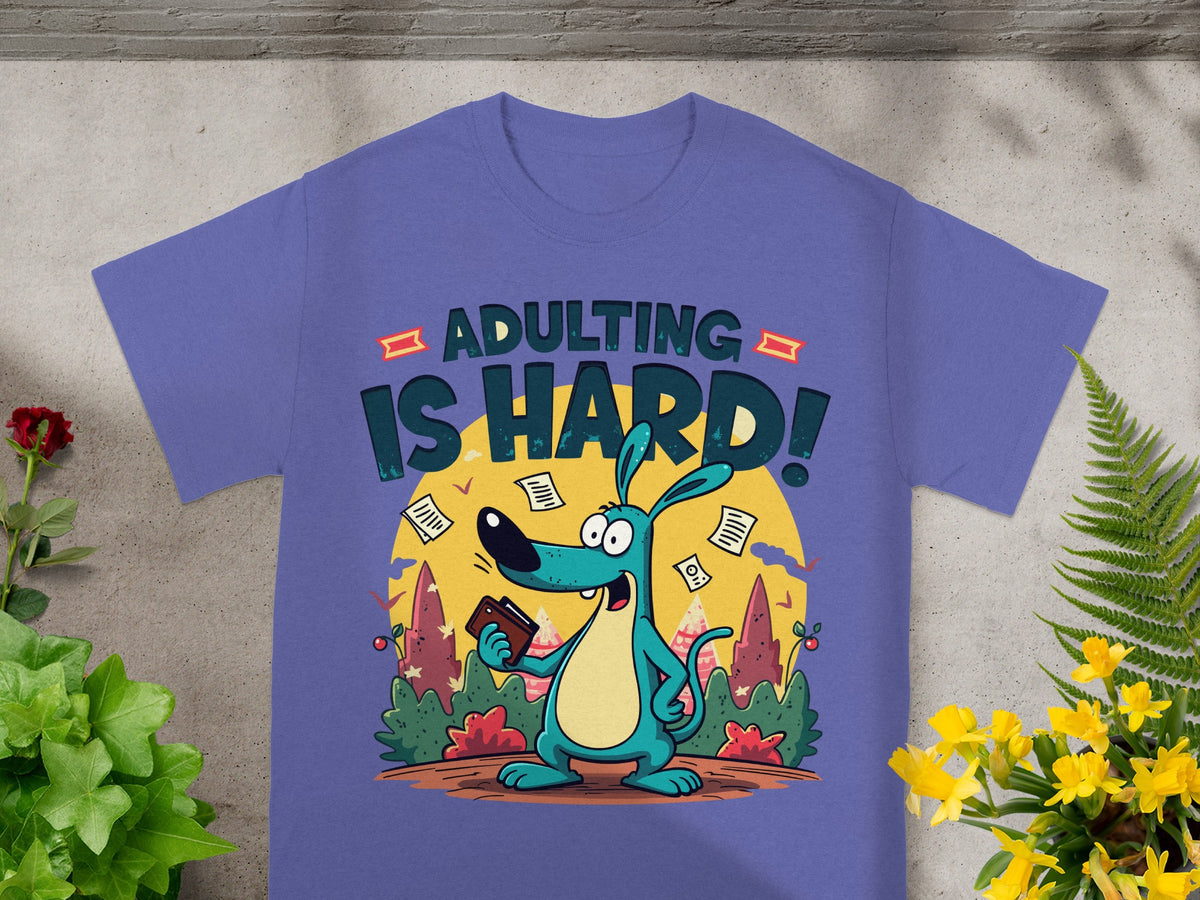 Purple t-shirt with a blue cartoon dog holding a wallet and text "ADULTING IS HARD!".