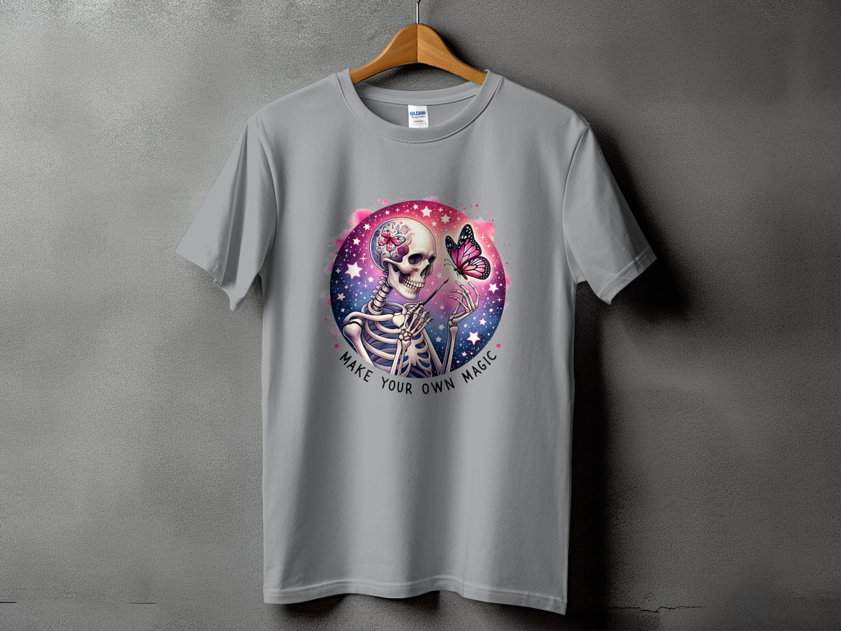 Grey t-shirt with skeleton and butterfly graphic, "Make Your Own Magic" text.