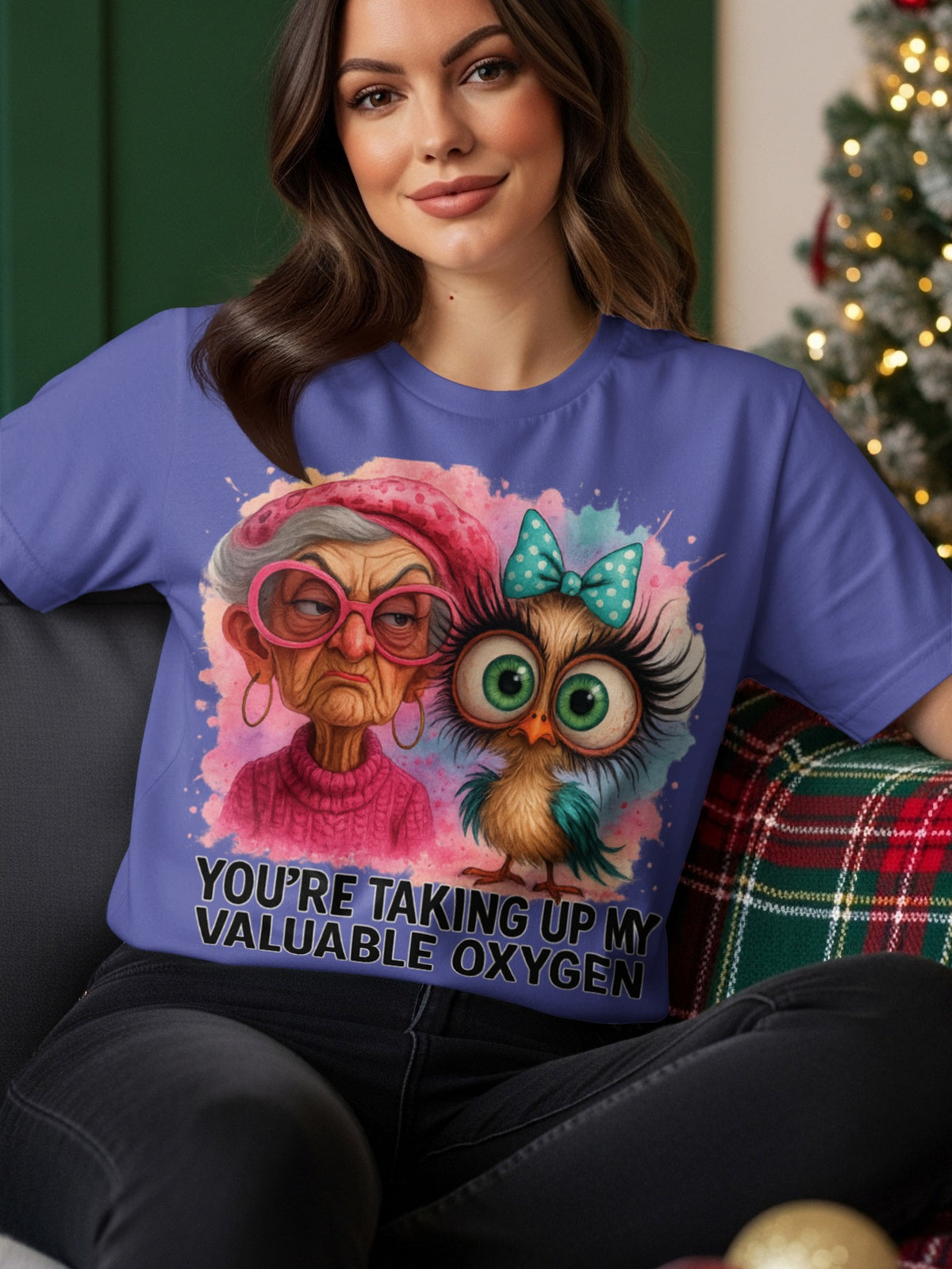 Woman wearing a purple t-shirt with an owl and text.