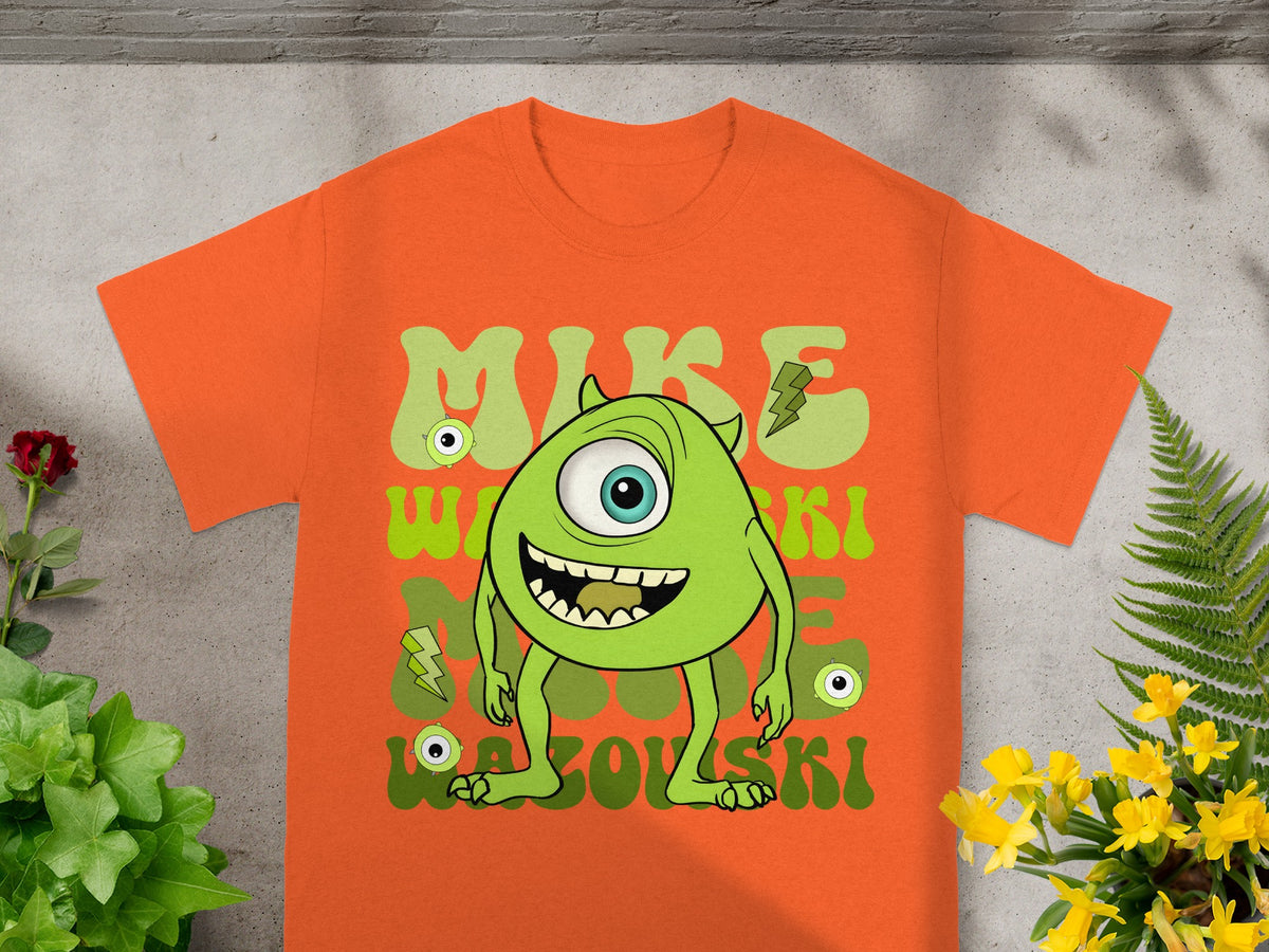 Orange t-shirt with Mike Wazowski monster graphic and text.