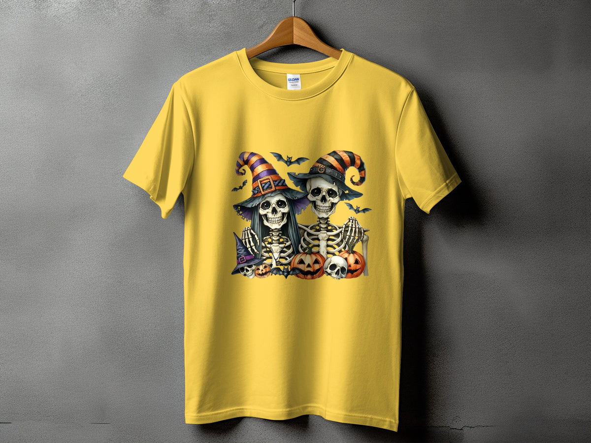 Yellow t-shirt with Halloween skeletons wearing striped hats and holding pumpkins.