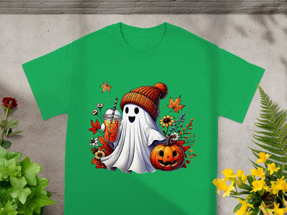 Green t-shirt with cartoon ghost holding drink and pumpkin, surrounded by leaves.