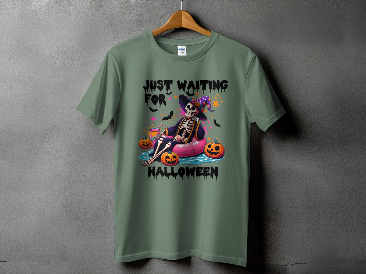 Green t-shirt with "Just Waiting for Halloween" text and skeleton on inflatable.