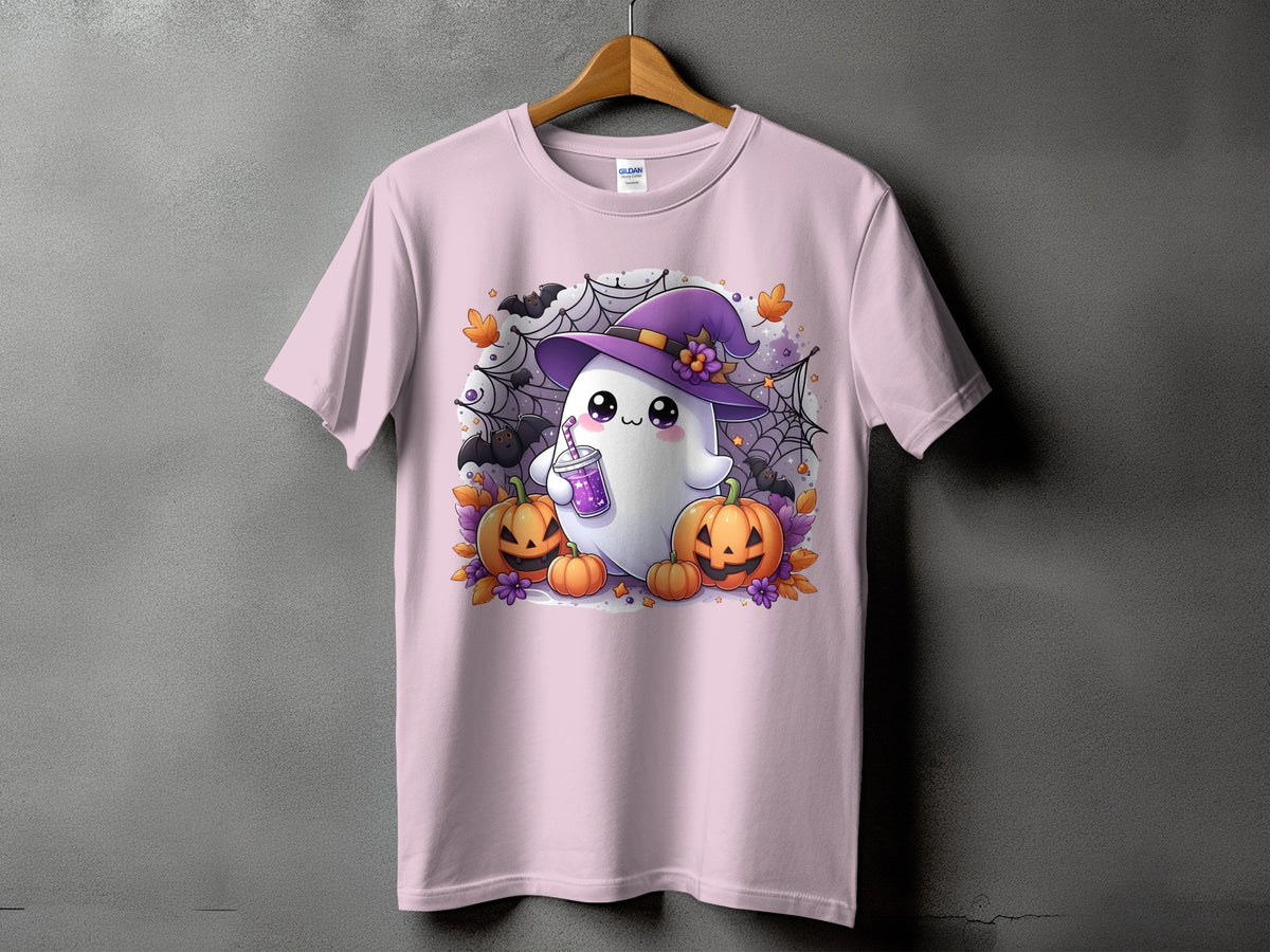 Pink t-shirt with a cute ghost wearing a witch hat and holding a drink, surrounded by pumpkins.