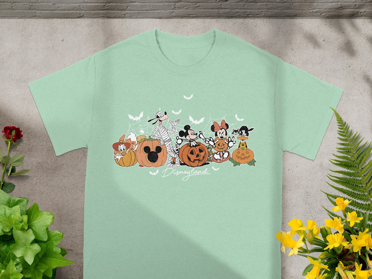 Disney characters in Halloween costumes with pumpkins and bats, with "Disneyland" text.