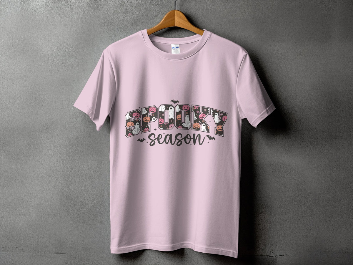 Pink t-shirt with "Spooky Season" text featuring Halloween icons.