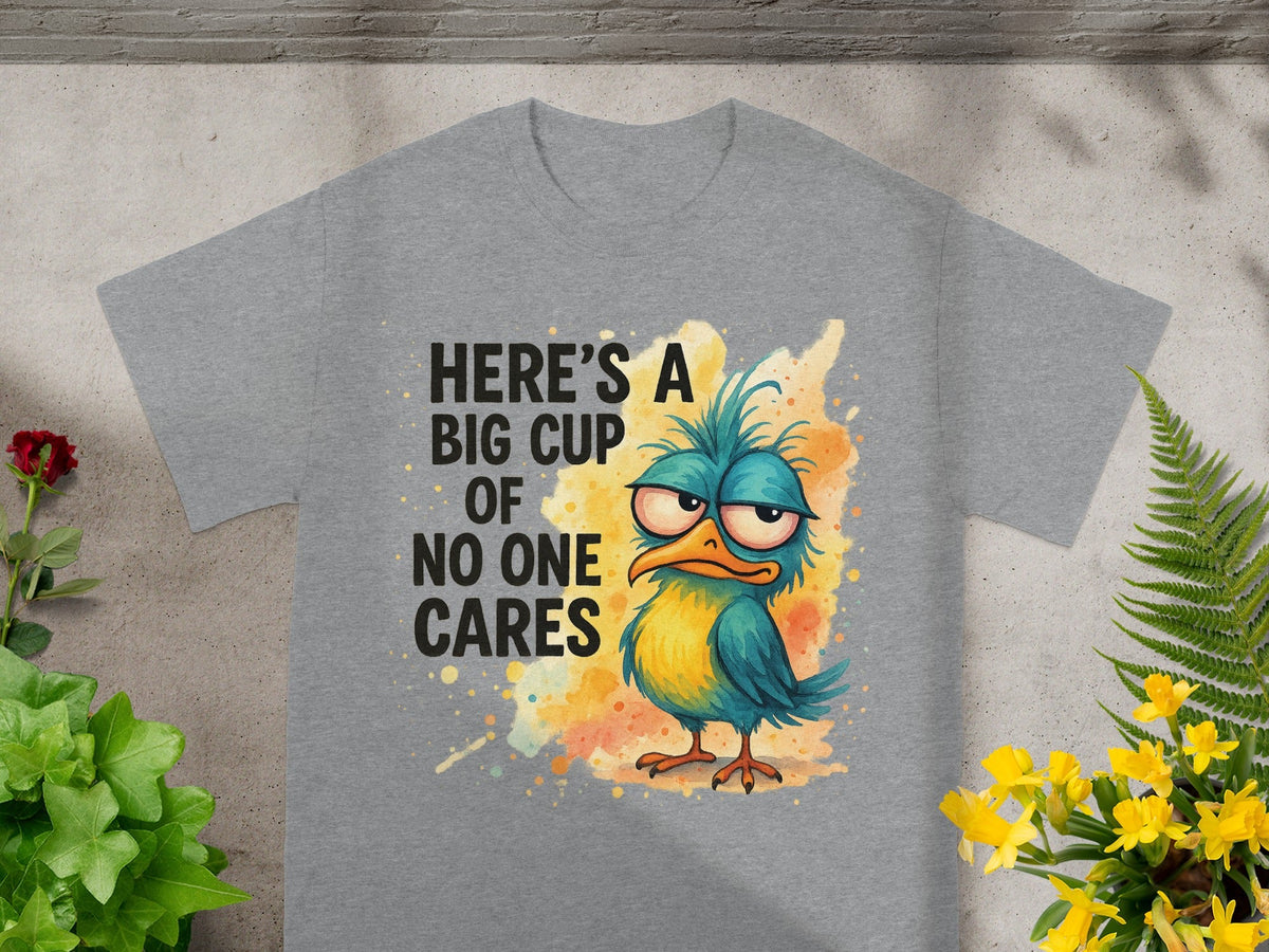 Grey t-shirt with a cartoon bird and text "HERE'S A BIG CUP OF NO ONE CARES".